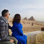 Tourists enjoying the view of the Giza pyramids in Egypt