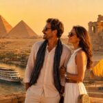 International couple overlooking the Great Pyramids of Giza with a luxury Nile Cruise, Luxor Temple, and the Grand Egyptian Museum representing a classic Egypt tour package.